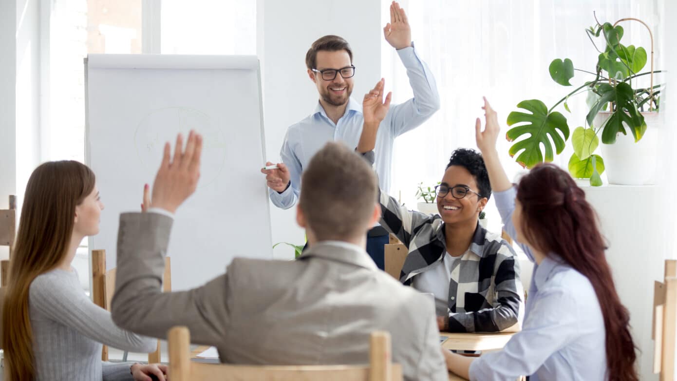 Group of corporate people participating in a discussion around a table.