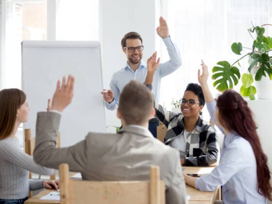 Group of corporate people participating in a discussion around a table.